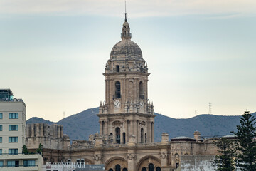 Fototapeta na wymiar Views of the buildings of the city of Malaga during the sunset, with the Church of the Incarnation