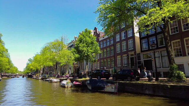  Traditional old narrow houses and canals in Amsterdam, the capital of the Netherlands in summer. High quality 4k footage