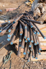 Reinforced steel bars on background of construction site with copy space. Metal base of reinforced concrete walls and buildings.