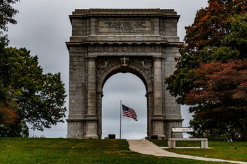 Fototapeta na wymiar National Memorial Arch and American Flag, Valley Forge National Historical Park, Pennsylvania, USA