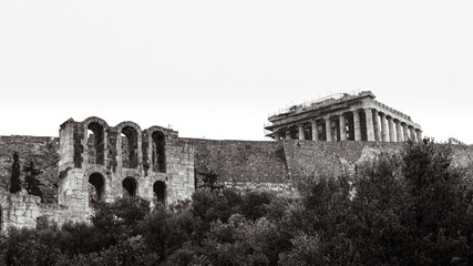Entrance arches to Odeon of Herodes Atticus in trees on hills of Acropolis and Parthenon, Athens,...
