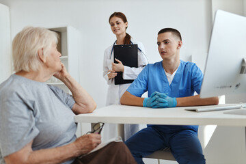 Fototapeta premium elderly woman on hospital nurse and doctor intercourse treatment