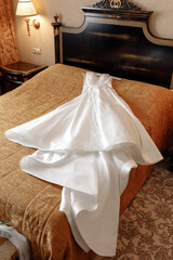 wedding white puffy dress on the bed waiting for the bride