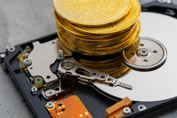 Stack of gold coins and a hard drive. Chia crypto