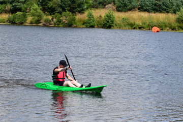 Green kayak in Loch Lomond during summer 