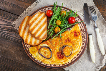 Omelet with tomato, onion, cheese and herbs. Tasty breakfast omelette. Top view