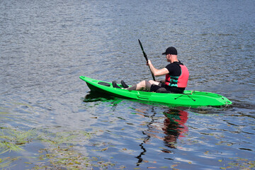 Fototapeta na wymiar Green kayak in Loch Lomond during summer 