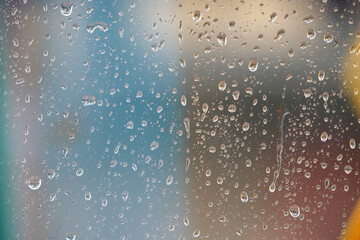 Raindrops on the glass of a shop window.