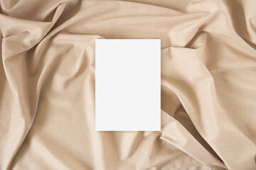 Mockup greeting card with on the nude fabric background