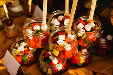 Greek salad in small glass jars at a banquet. catering 