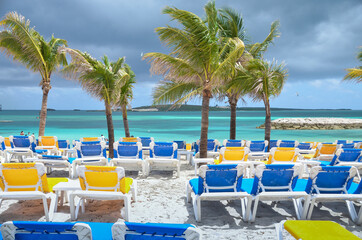 Summer vacation on beach island with palm trees and loungers