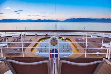 Aft View of cruise ship pool and mountains at dusk