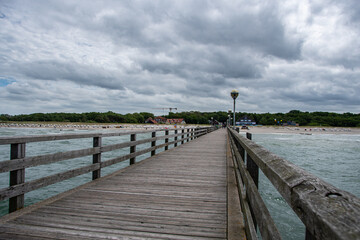 Obraz premium The view from the Graal-Müritz pier to the Baltic Sea and the beach