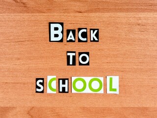 letters Back to school cut from a magazine on a wooden background