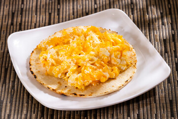 Traditional Colombian breakfast - Arepa and egg.