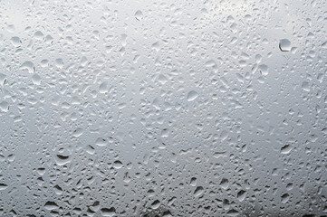 Rain drops on a window with blurred background. Selective focus.