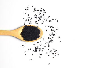 Nigella sativa or Black cumin in wooden spoon isolated on white background
