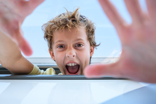 Funny Boy Reaching Out To Camera From Trailer Window