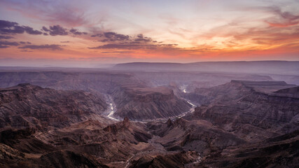 Fototapeta na wymiar Sunset over the Fish River Canyon in Namibia, the second largest canyon in the world and the largest in Africa. 