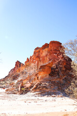Amazing Rainbow Valley in Northern Territory, Australia, just outisde Alice Springs.  Beautiful red and orange rock formation with blue sky and orange sands