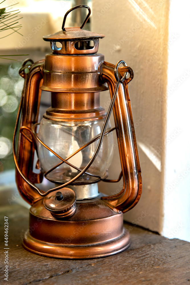 Wall mural a vintage shiny metallic copper lantern lamp.