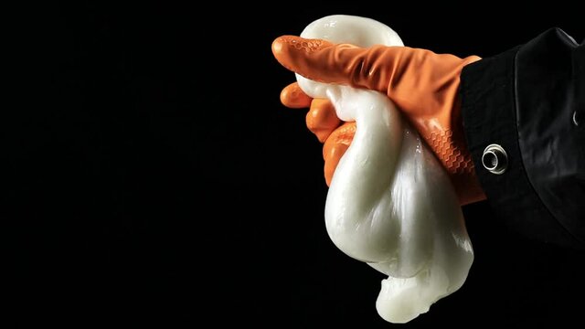 one hand holding slime made from styrofoam dissolved in acetone