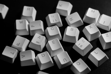 Random letters of keycaps or keyboard buttons on black background. Random Alphabet.
