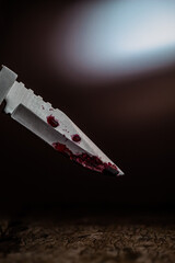 Knife with blood on a table