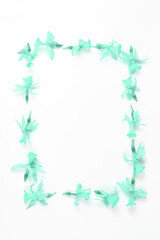 minimalistic floral frame. dried flowers of turquoise color on a white background. flat lay, space for text, vertical frame