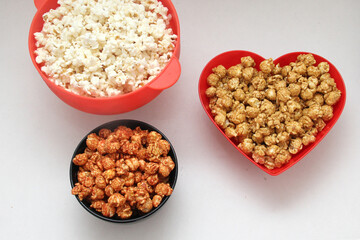 Flavored popcorn: natural, with chili and with caramel, Variety of snacks with drinks ready to see a movie

