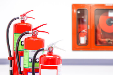 Fire extinguisher, Close-up red fire extinguishers tank with fire hose cabinet in the building concepts of protection and prevent for emergency and safety rescue and fire training.