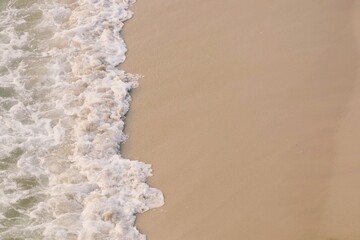 Fototapeta na wymiar Sand and foam wave.
