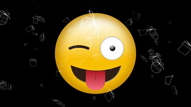 Digital animation of multiple christmas icons over silly face emoji against black background