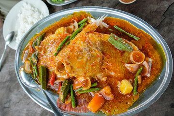 Popular Chinese restaurant dishes. Assam Tilapia & Thai Fried Basil Omelette. Hot and spicy, cooked to perfection with tomato, okra, long bean, onion, red chiliand pineapple cubes.