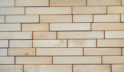 Background is made of wooden bricks. Decorative wall made of plywood parts. Pattern.