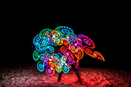 A Baton Show Made Of Colorful LED Lights With Beautiful Patterns That Change As The Lights Twirling.