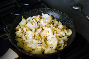 The potatoes are fried in a pan. Cooking at home.