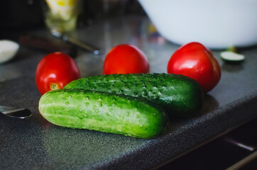 Delicious cucumbers and tomatoes on the cooking table. Healthy lifestyle