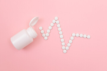 Heartbeat Rhythm. Electrocardiogram. ECG Line Made from White Pills Scattered from the Pill Container, Lying on Pink Background. Global Pharmaceutical Industry and Medicinal Products
