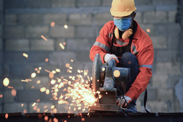 Worker cut steel with cutting machine circular disc cuts off part of iron until