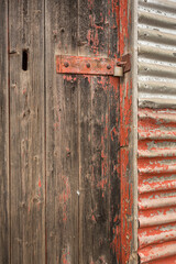 Weathered timber door with padlock