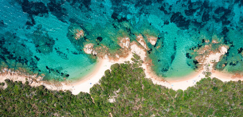 View from above, stunning aerial view of a rocky coastline with some beaches bathed by a beautiful and turquoise sea. Liscia Ruja,Sardinia, Italy.