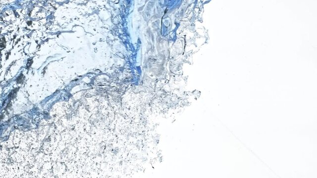 Super Slow Motion Shot of Side Water Splash Isolated on White Background at 1000fps.