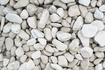 White smooth large stones, decorative element for garden and landscape. Textured stone background top view, outdoors.