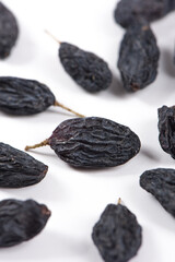 Dried black raisins isolated on white background