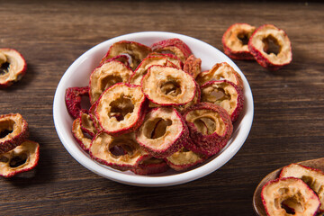 Dried hawthorn slices on wooden  background