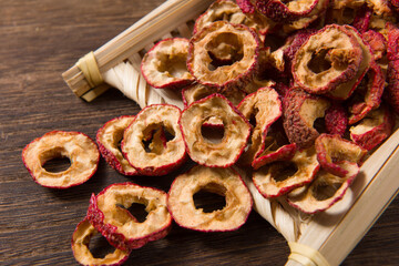 Dried hawthorn slices on wooden  background