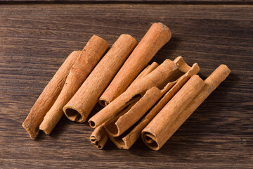 Aromatic dry cinnamon sticks on wooden background