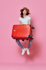 cheerful woman with suitcase luggage travel entertainment pink background