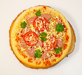 Top view of to-be-baked pepperoni tomato pizza on a white background